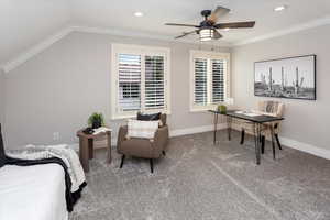 Bedroom with crown molding, vaulted ceiling, ceiling fan, and carpet flooring