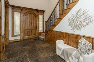 Foyer with wood walls