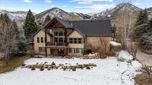 Snow covered property with a mountain view