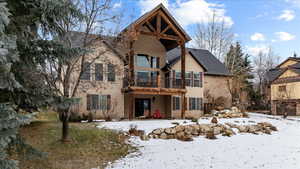 Snow covered house with a balcony