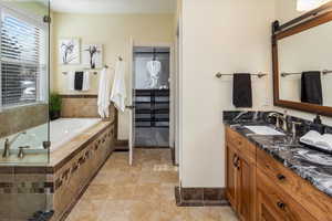 Bathroom with a relaxing tiled tub and vanity