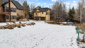 Yard covered in snow featuring a balcony