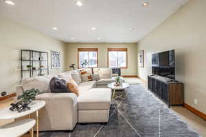 Living room featuring dark colored carpet