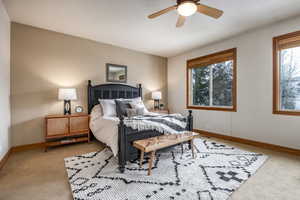 Bedroom featuring ceiling fan and light colored carpet