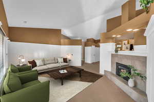 Living room featuring a tiled fireplace, carpet, and lofted ceiling