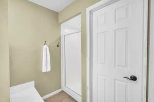 Bathroom featuring a textured ceiling and walk in shower