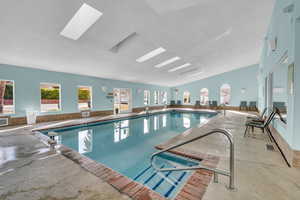 View of pool with a skylight