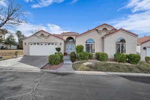 Mediterranean / spanish home featuring a garage