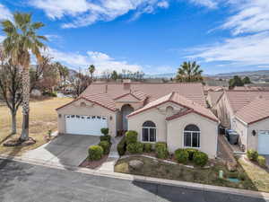 Mediterranean / spanish-style house featuring a garage