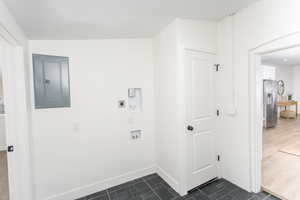 Washroom featuring washer hookup, electric panel, and electric dryer hookup