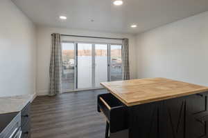 Kitchen with wooden counters and dark hardwood / wood-style flooring