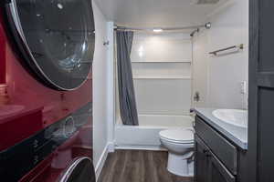 Full bathroom with vanity, wood-type flooring, shower / tub combo, and toilet