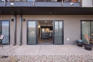 Entrance to property featuring sink and a patio