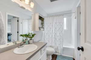 Full bathroom featuring vanity, wood-type flooring, shower / bath combination and toilet