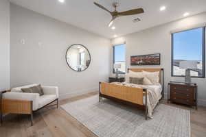 Bedroom with ceiling fan and light wood-type flooring