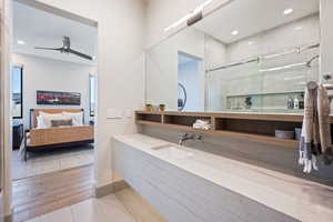 Bathroom featuring vanity, tile patterned floors, ceiling fan, and walk in shower