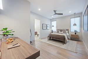 Bedroom with ensuite bath and light hardwood / wood-style flooring