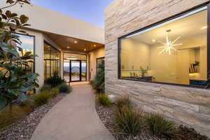 Exterior entry at dusk with ceiling fan