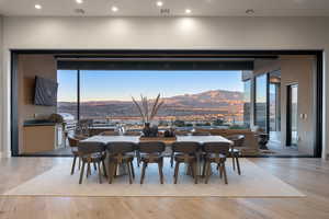 Dining area featuring a mountain view, a wealth of natural light, and light hardwood / wood-style flooring