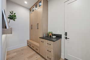 Mudroom with light hardwood / wood-style flooring