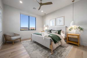 Bedroom with hardwood / wood-style flooring and ceiling fan