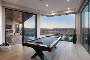 Rec room featuring pool table, light hardwood / wood-style flooring, and floor to ceiling windows