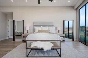 Bedroom featuring ceiling fan, access to outside, and light hardwood / wood-style floors