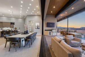 Dining space with floor to ceiling windows and sink