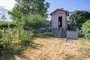 View of yard with a storage unit