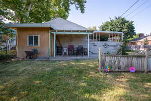 Rear view of house with a yard