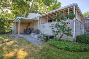 Rear view of property featuring a yard