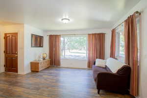 Sitting room featuring dark wood-type flooring