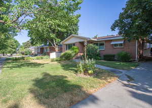 Ranch-style house featuring a front lawn