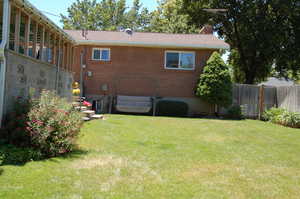 Rear view of house featuring a lawn