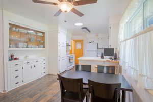 Dining space featuring dark hardwood / wood-style floors and ceiling fan