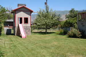 View of yard with a mountain view and an outbuilding