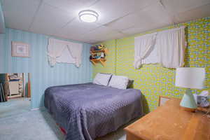 Carpeted bedroom with a drop ceiling