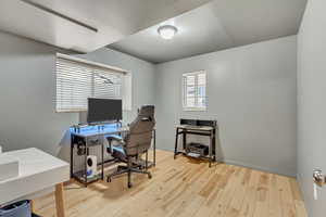 Office with light hardwood / wood-style flooring