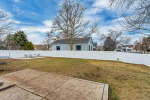 View of yard featuring a trampoline and a patio area