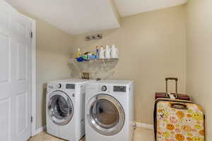 Clothes washing area featuring separate washer and dryer