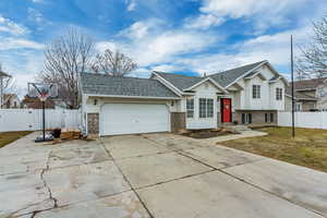 View of front of home featuring a garage and a front yard