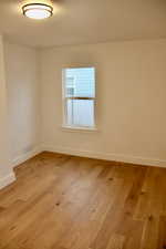 Empty room featuring light wood-type flooring