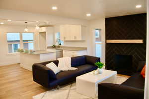 Living room featuring sink and light hardwood / wood-style floors