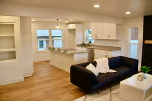 Living room featuring sink and light hardwood / wood-style floors