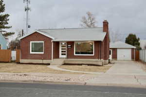 Ranch-style house with a garage and an outdoor structure