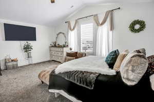 Bedroom with lofted ceiling, carpet flooring, and ceiling fan