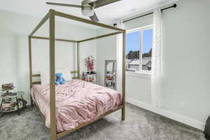 Carpeted bedroom with ceiling fan