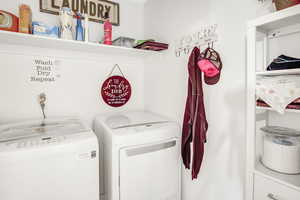 Clothes washing area featuring washing machine and clothes dryer