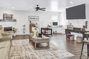 Living room featuring ceiling fan and wood-type flooring