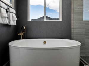 Bathroom featuring a tub to relax in